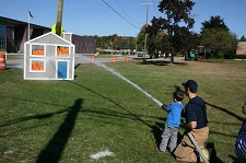 Fireman with hose on a demonstration fire