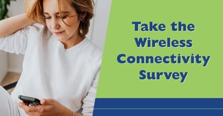 Woman looking at her cell phone with headline Share Your Experience with Wireless Coverage