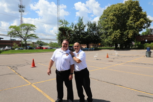 Two men wearing Fire Department polos posing happily for camera